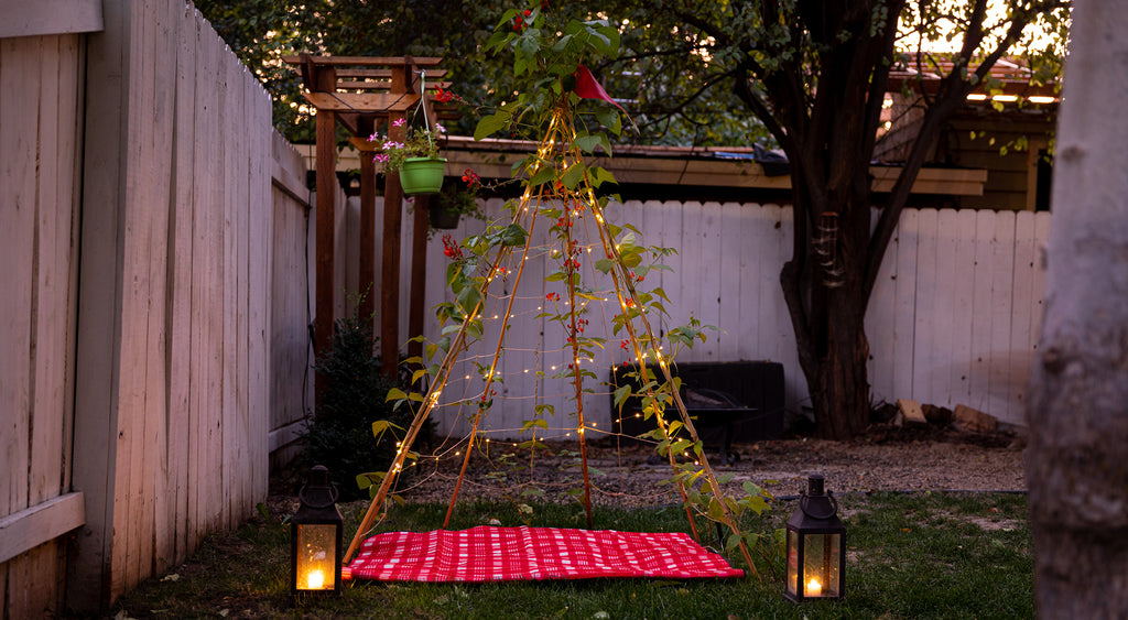 solar string lights and lanterns at dusk on backyard play tent bean teepee